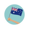 Australia waving flag circle icon. Hand holding Australian flag. National symbol with Southern Cross constellation. Royalty Free Stock Photo